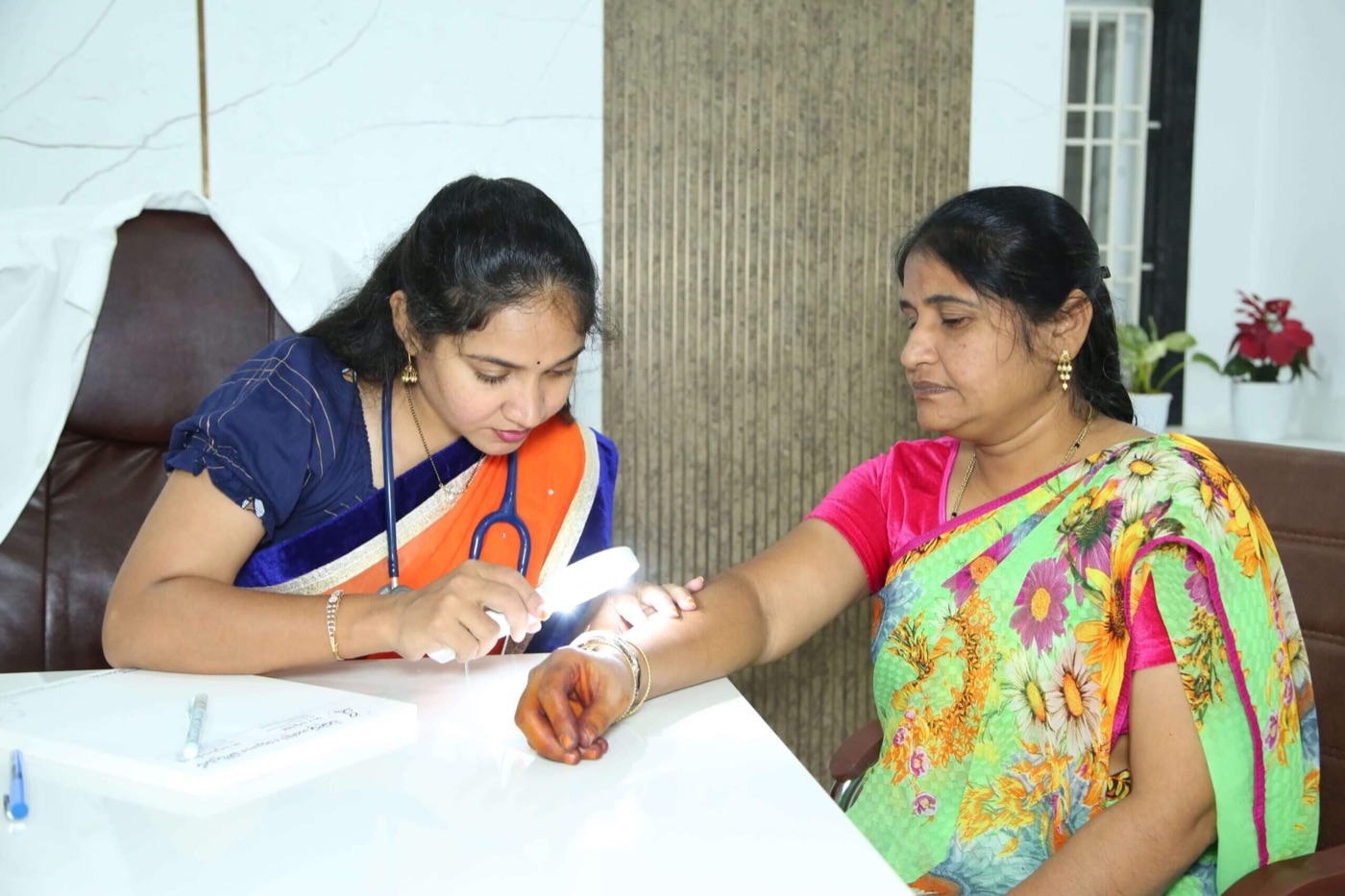 Dr Preethi Pellakuru examining a patient
